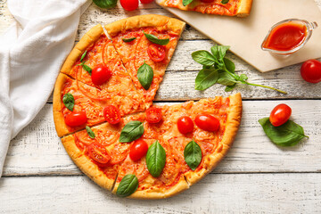 Board with tasty pizza margarita on white wooden background