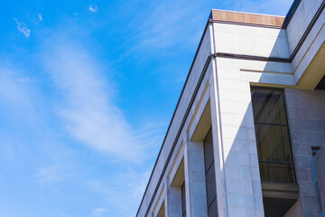 Crystal Reflections: A Building Facade of Grey Granite and Shimmering Glass Panels