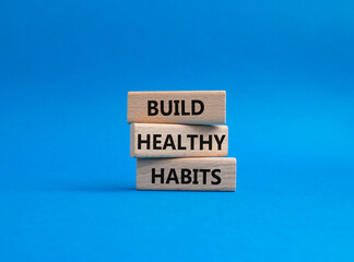 Healthy habits symbol. Concept word Build Healthy habits on wooden blocks. Beautiful blue background. Healthy lifestyle and Healthy habits concept. Copy space