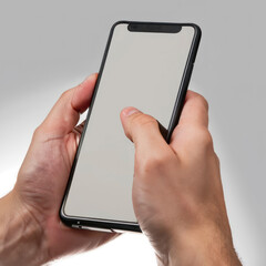 Hand of a man holding a black smartphone isolated on white 
