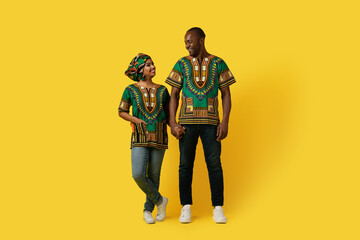 Loving black couple looking at each other on yellow background