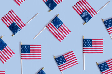 Pattern from USA flags top view, flat lay on blue background. Independence day concept.