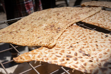 traditional huge iran bread on a metal grid table