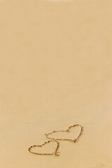 Heart drawn on the wet sand on the beach. Concept of love; romance; feelings.