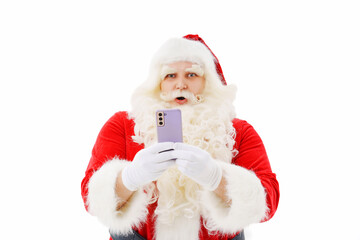 Santa Claus is surprised with a smartphone in his hands on a white background. 