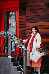 beautiful brunette on the stairs with shopping. winter city