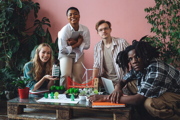 International diverse group of students working on modern urban architecture project with renewable green energy source, alternative electricity, waste recycling. Brainstorming ideas, business plan