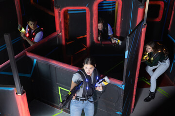 Team of young people play laser tag in a labyrinth. View from above