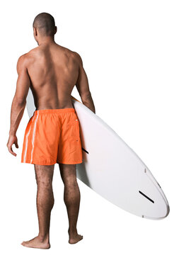 Man of a surfer walking to the ocean during sunset