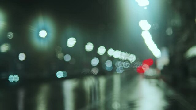 Blurred view of rainy night city road