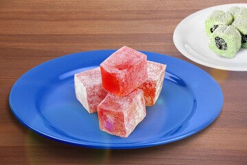 Tasty sweet candy on plate on desk