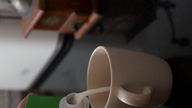 pour plant milk drink into a cup in the morning
