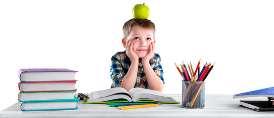 Happy school child with school supplies, sitting at a desk learning in class