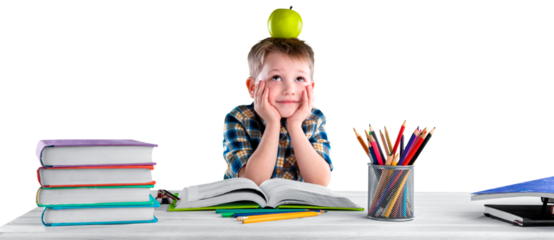 Happy school child with school supplies, sitting at a desk learning in class