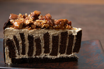 a slice of Almond Chocolate cake on rustic background