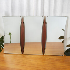 Vintage 1960s Triptych Mirror. Mid-Century Modern walnut furniture. Against a luxurious white...