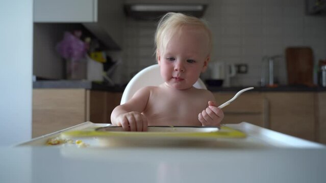 A cute doll sits at the table and strikes that she's run out of food 4k