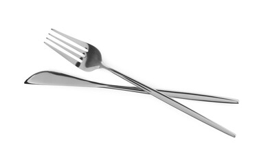 Fork and knife isolated on white, top view. Stylish shiny cutlery set