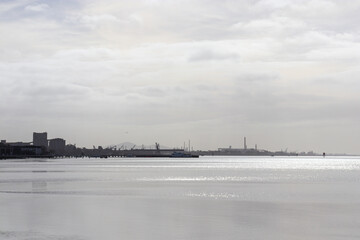 Fototapeta premium sea landscape with view of ports and city in morning sunlight
