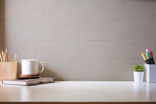 Simple workplace with coffee cup, notebook and stationery.Copy space for your advertise text. © wattana