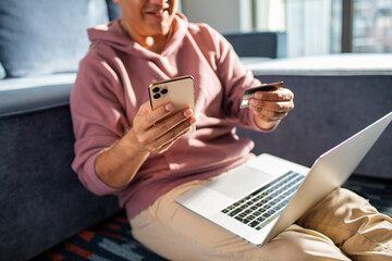 Middle aged latin man online shopping on his laptop