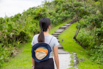 Woman walk along the hiking trail in countryside