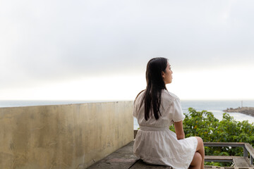 Woman sit outside enjoy the sea view