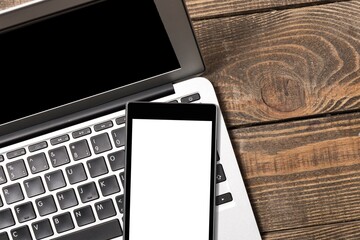 Blank screen smartphone on computer keyboard