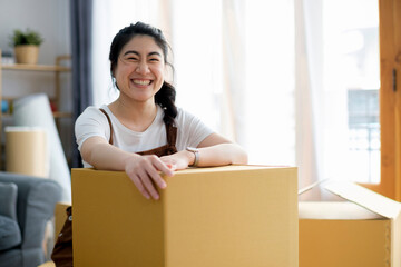 Happy woman smiling at home during move with boxes