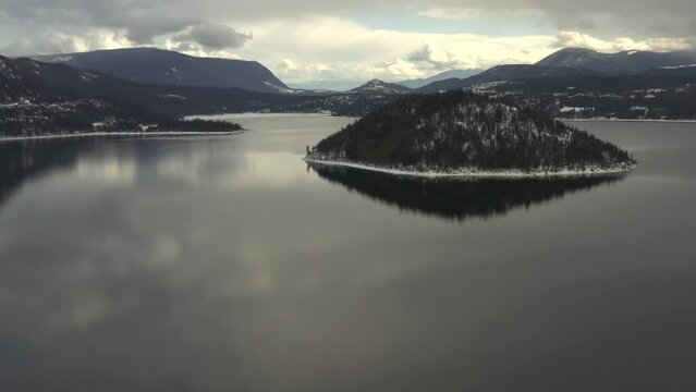 Cloudy Day Bliss at Copper Island: Aerial Views of Shuswap Lake's Serene Reflections and Stunning Mountains