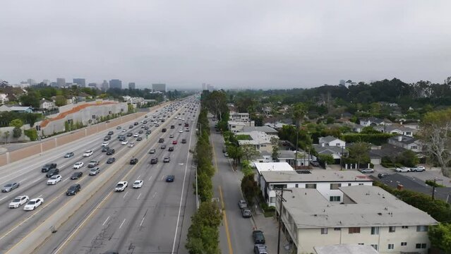 Aerial view over the Brentwood Glen suburbs and traffic on I-405 in cloudy Los Angeles, USA