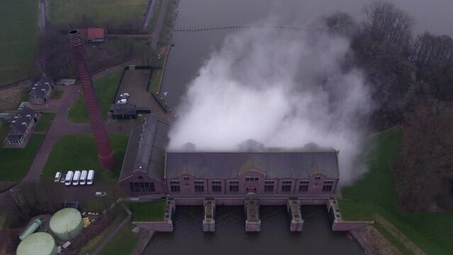 Drone shot of D.F. Woudagemaal Steam Pumping Station with steam rising, Aerial