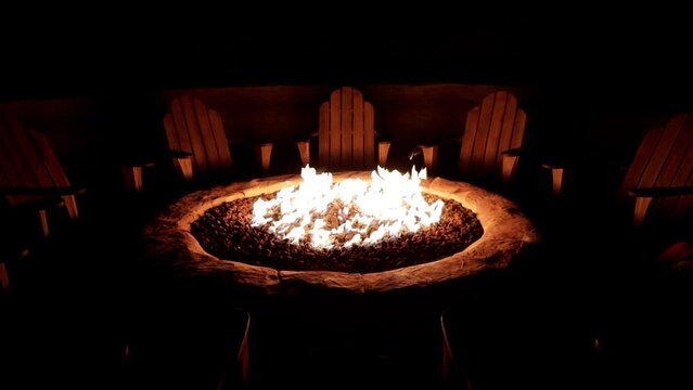 Chairs arranged around a cozy backyard fire pit.