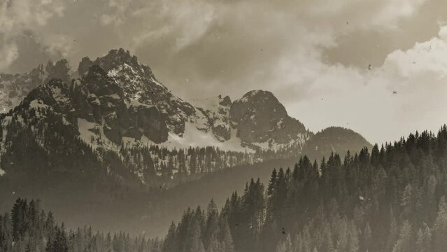 Vintage scratched footage of a mountain landscape, location: Dolomites, South Tyrol, Italy, 4k timel-apse