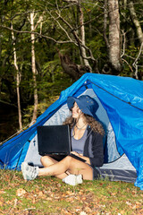 Forest Freelancer: A Woman Embracing Nature while Working on her Laptop