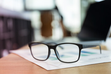 Glasses lying on papers in office, work in office concept