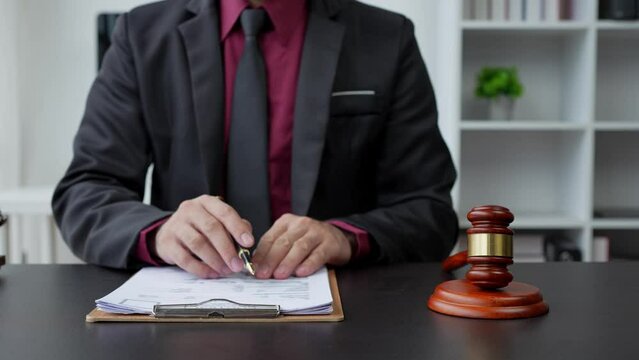 Law and justice concept Young lawyer or Asian legal advisor explaining contract rules to a consultant in a law firm.	