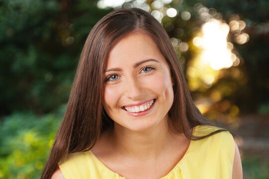Young happy woman portrait on outdoor background