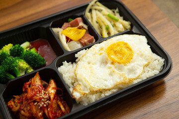 Side dishes and rice in takeout containers