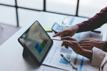Business people meeting explaining the financial graph data and marketing plan on tablet. Group of business people at meeting assessment the state of business investment and marketing.