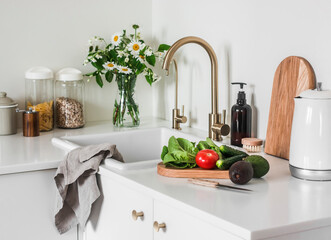 Kitchen interior. Vegetables for salad preparation on the kitchen table