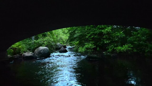 Flying Under The Stone Bridge Over The Eightmile River To The Forest In Devils Hopyard State Park In Connecticut, USA. - aerial
