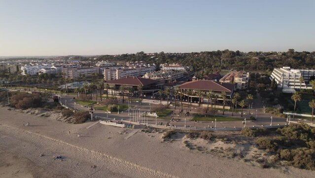 Calm and relaxing summer evening in Islantilla Spain, aerial orbit in sunset