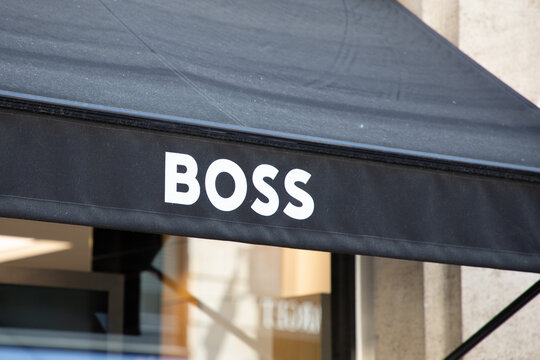 hugo boss logo brand and text on shop facade wall sign in the main shopping street of the city