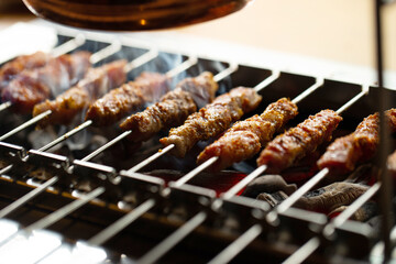 Grilled lamb skewers over charcoal	