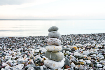 Stone tower on the beach. Cairn. Symbol of balance.
