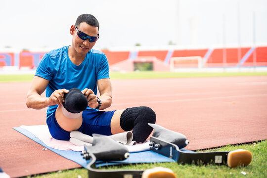 Asian para-athlete disabled wearing prosthetic blades at the stadium