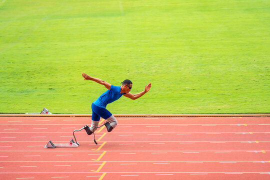 Asian para-athletes disabled with prosthetic blades running at stadium