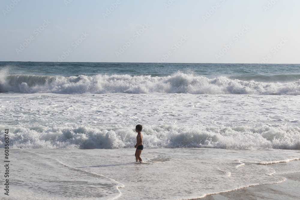 Canvas Prints boy on the beach running on the waves of the sea