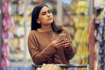 Choice, shopping and phone with woman in supermarket for grocery, research and cooking app....